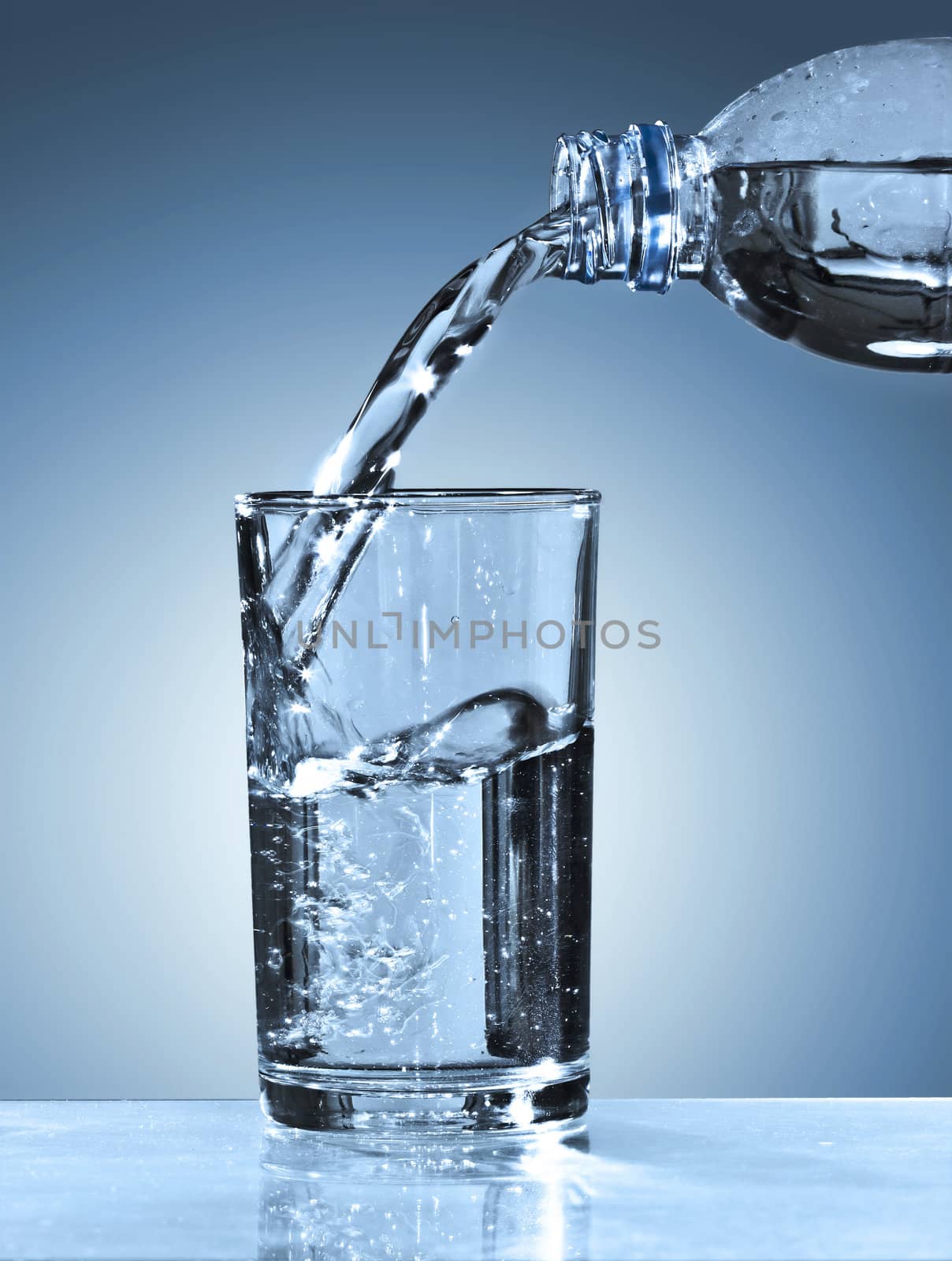 Glass and bottle with pure water on blue background