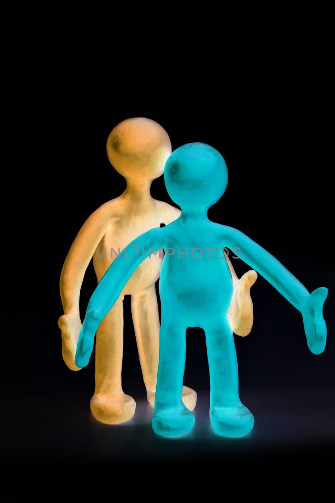 Two shaded plasticine puppets standing on black background