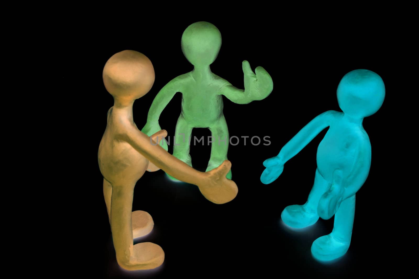 Three shaded plasticine puppets talking on black background