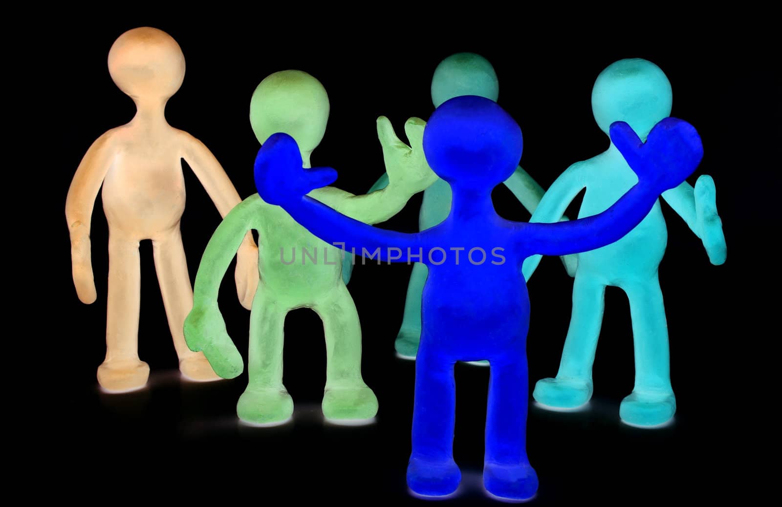 Shaded group of plasticine puppets on black background