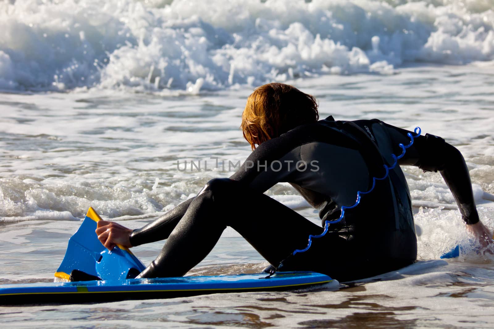 SAN FERNANDO, CADIZ, SPAIN - FEB 19: Unknown bodyboader going to the water on the 2nd championship of Surf and BodyBoard Impoxibol on Feb 19,2011 on the beach of Camposoto of San Fernando, Cadiz, Spain