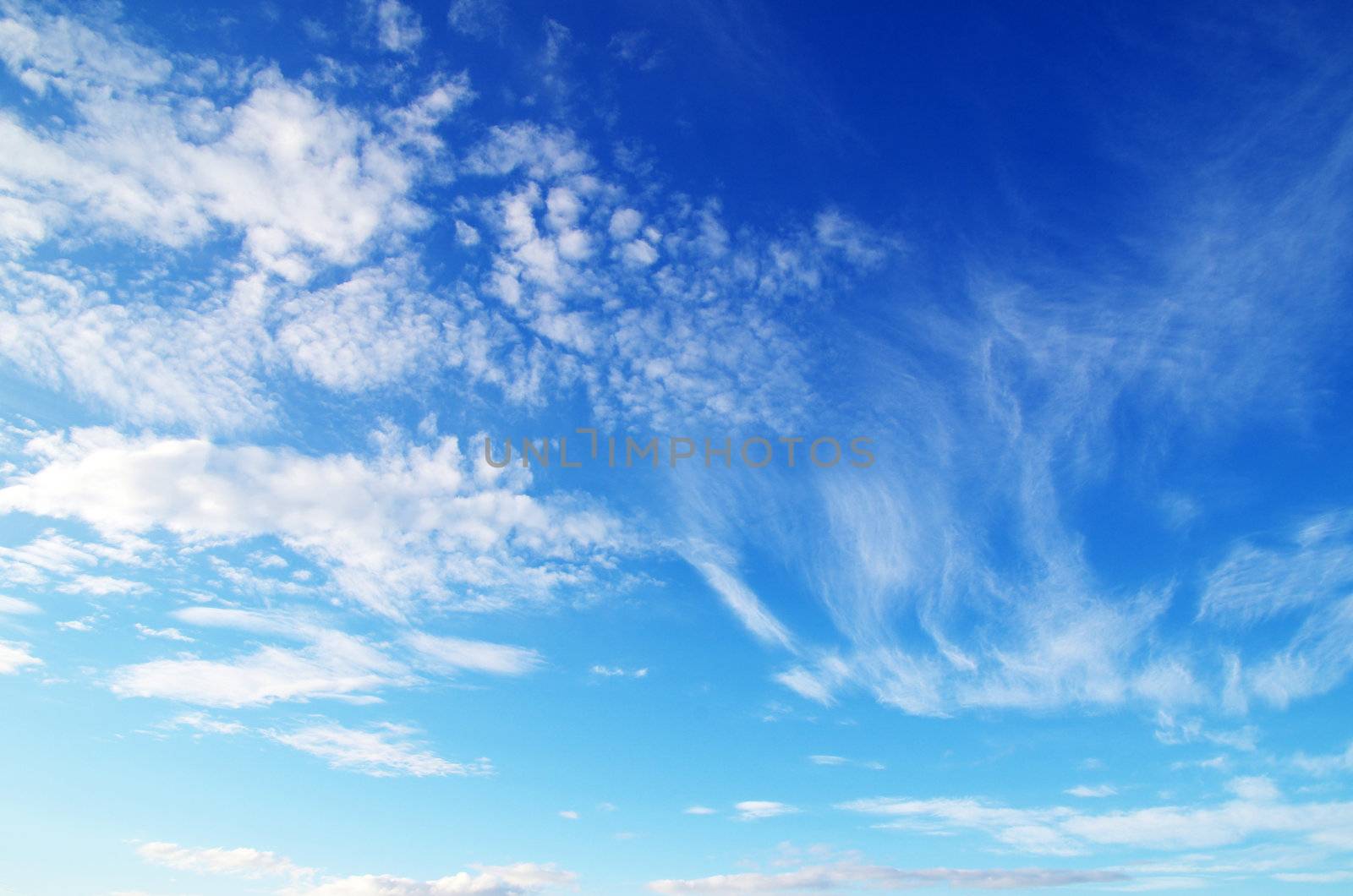 blue sky background with tiny clouds