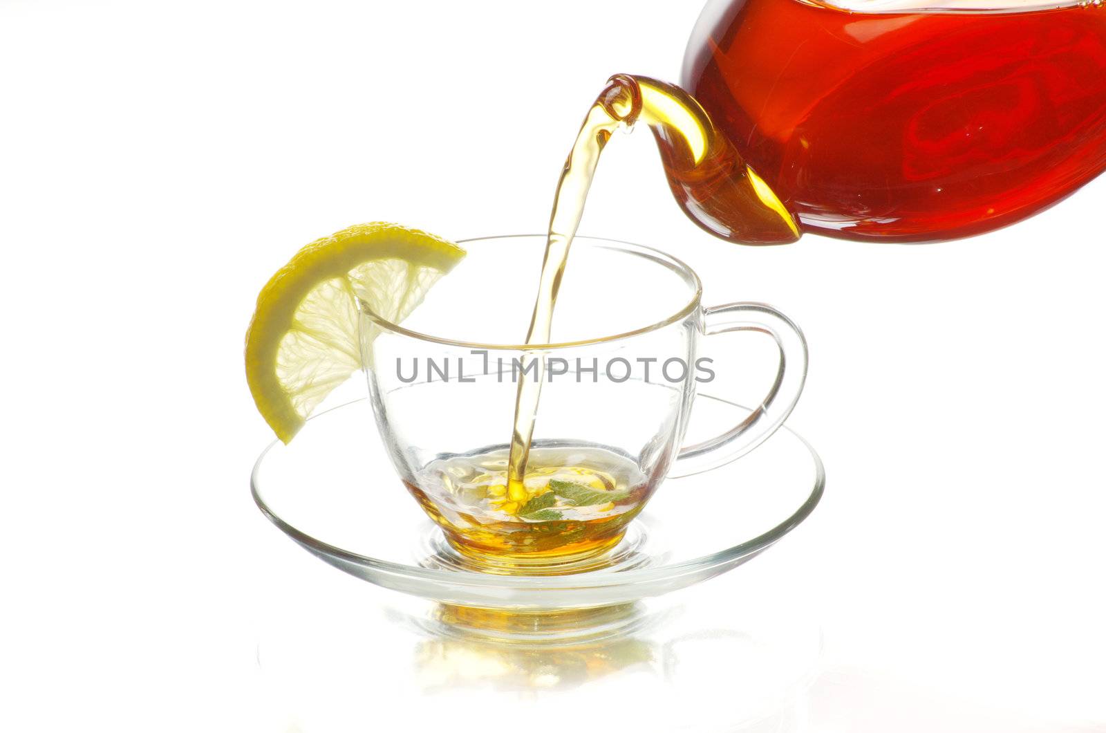 Tea being poured into glass tea cup