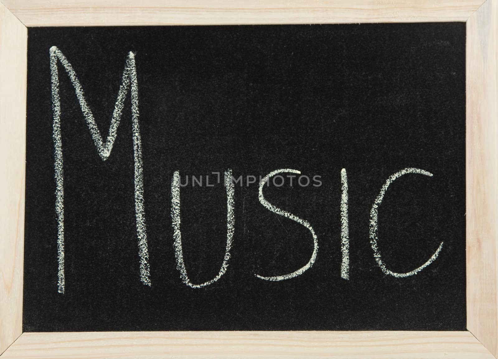 A black board with a wooden frame and the word 'MUSIC' written in chalk.