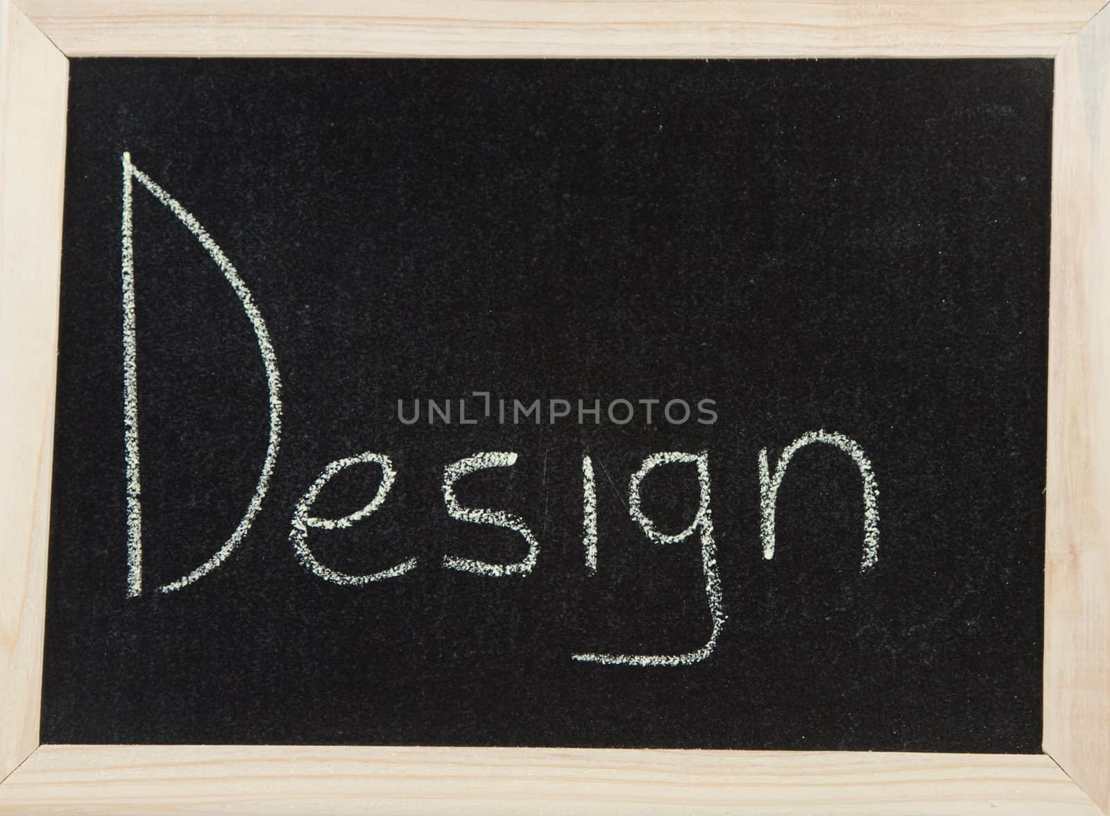 A black board with a wooden frame and the word 'DESIGN' written in chalk.