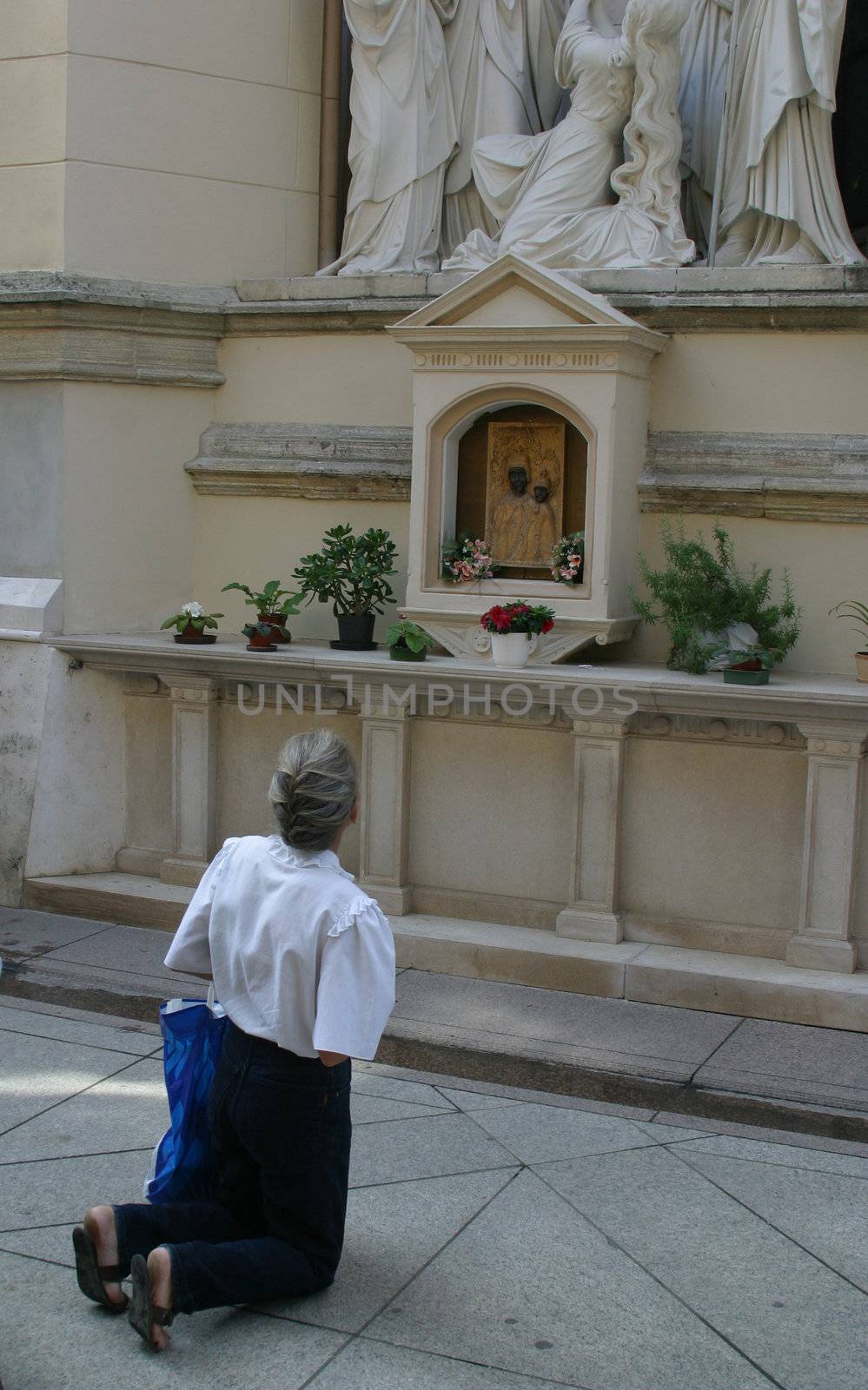 MARIJA BISTRICA, CROATIA - AUGUST 15: pilgrim praying before a crucifix on the Feast of the Assumption Croatian national shrine of the Virgin Mary on August 15, 2010 in Marija Bistrica, Croatia.