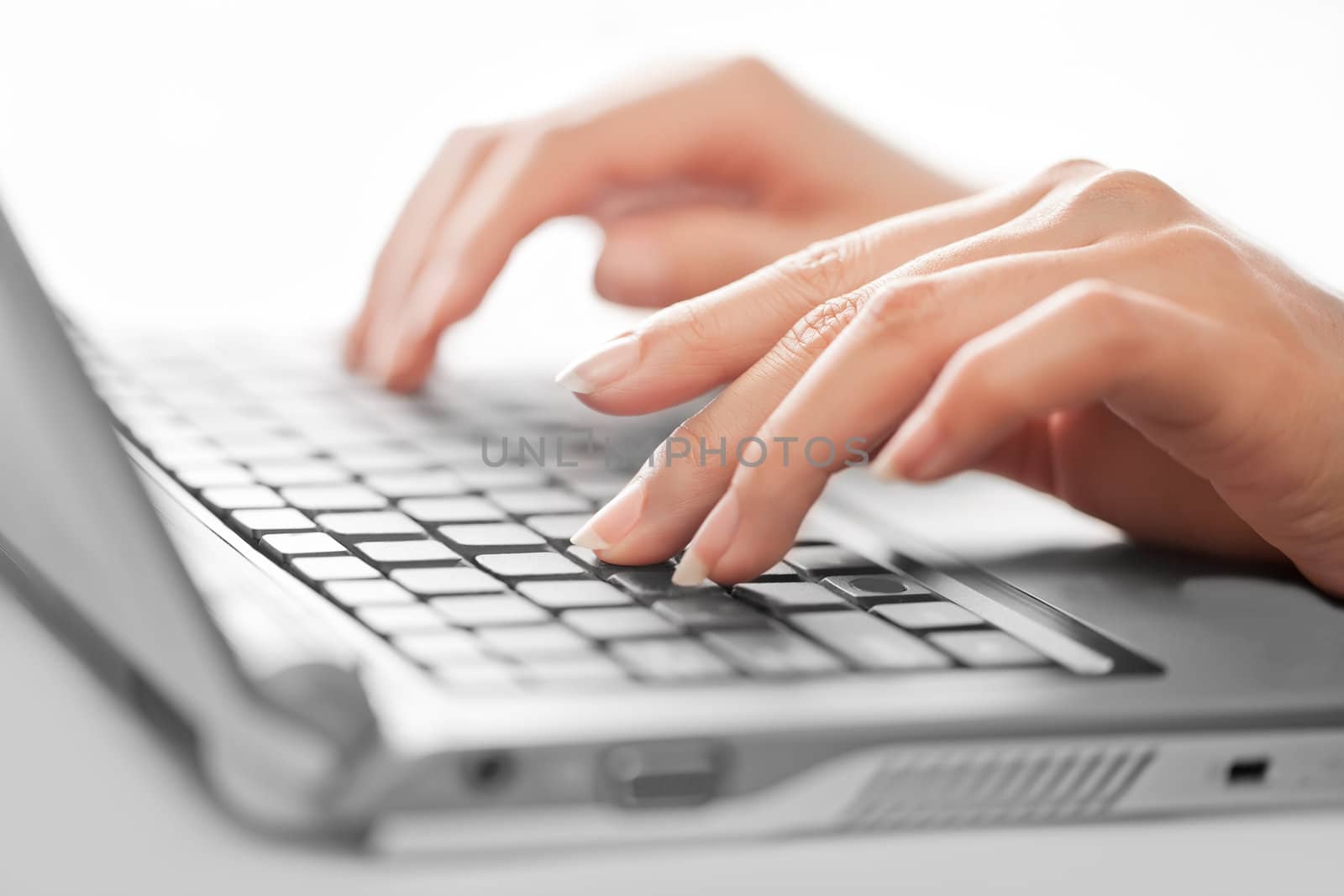 Close-up of typing female hands, selective focus