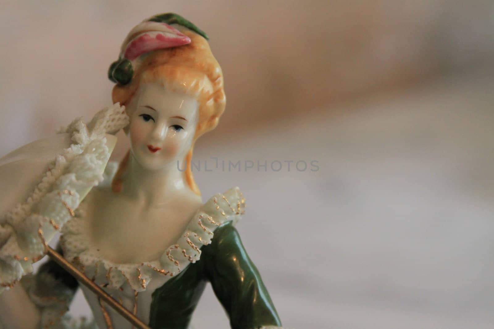 Antique figurine close up over background.