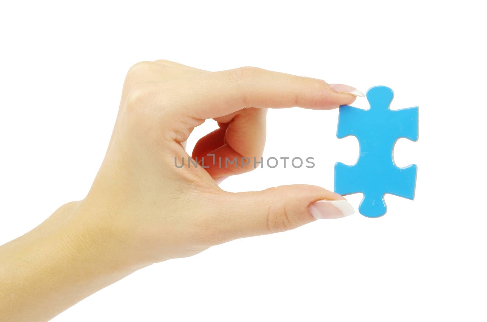 hand holding a puzzle piece