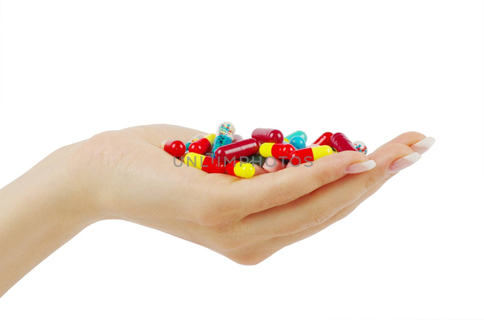 hand holds pill isolated on white