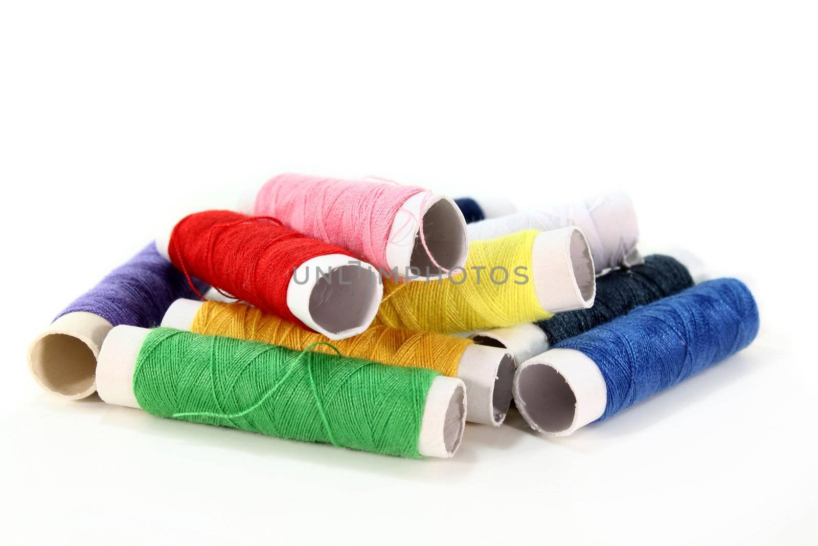 colorful spools of thread on a white background