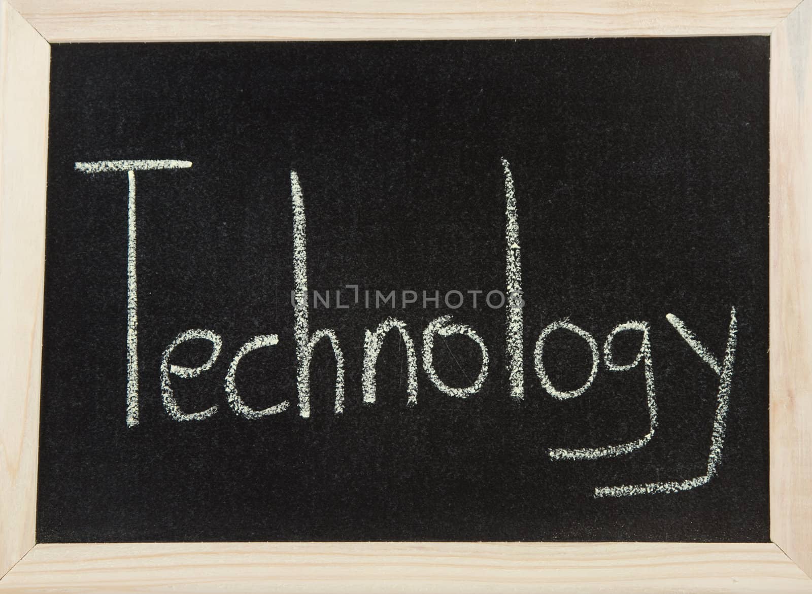 A black board with a wooden frame and the word 'TECHNOLOGY' written in chalk.