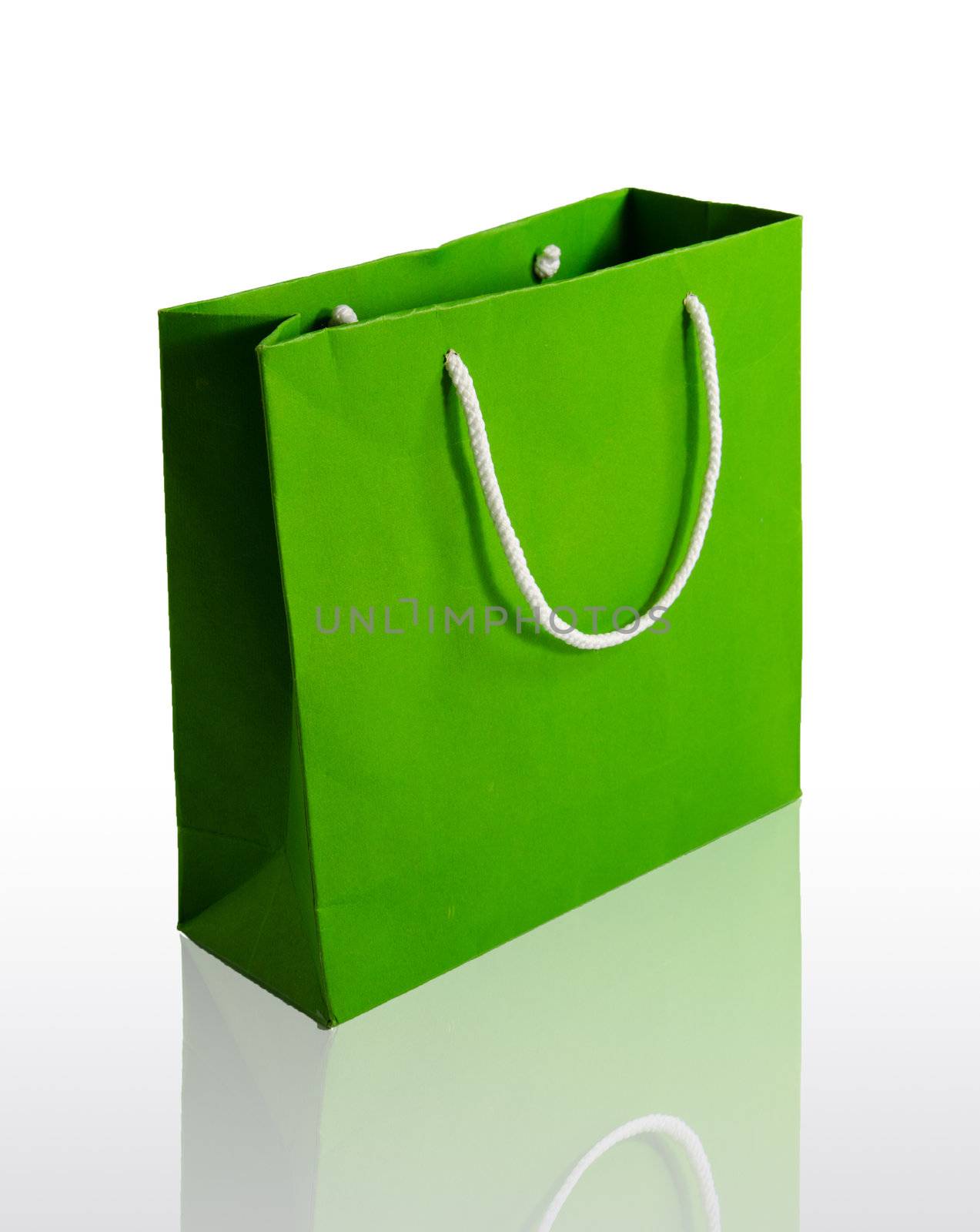 Green paper bag on reflect floor and white background