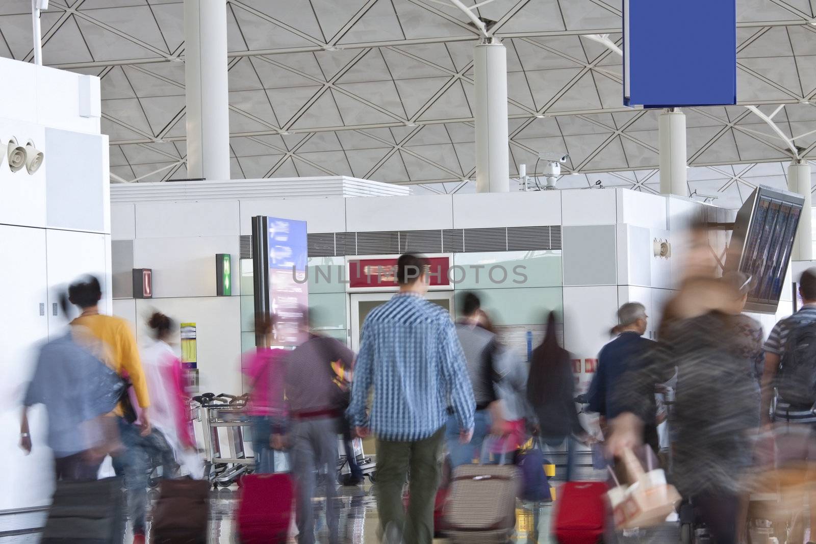 Fast moving passengers at airport modern building