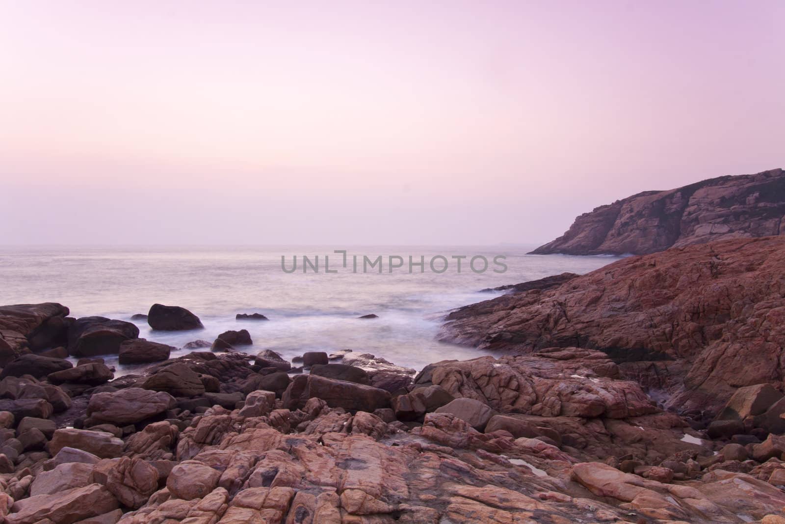 Sunrise along seashore under long exposure