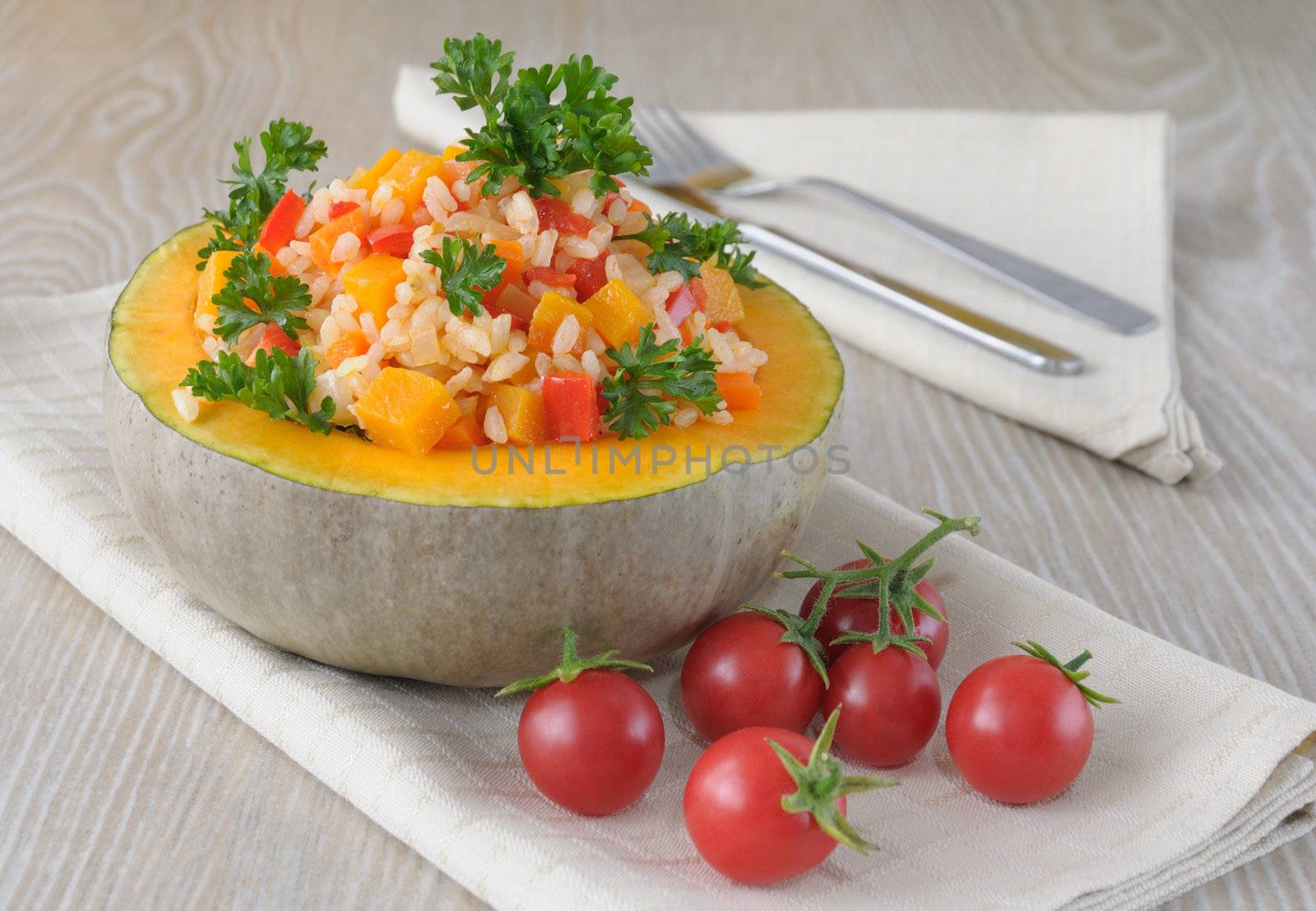 Rice porridge with pumpkin and vegetables in a bowl of pumpkin and tomatoes