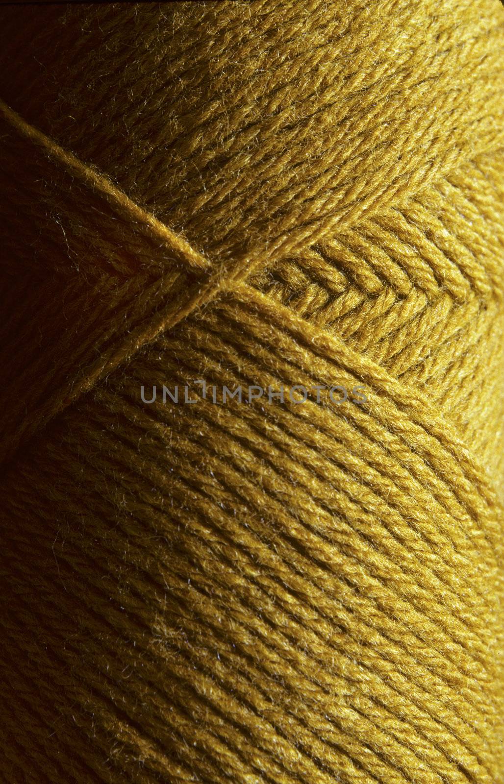 Close-up of a skein of gold wool knitting yarn