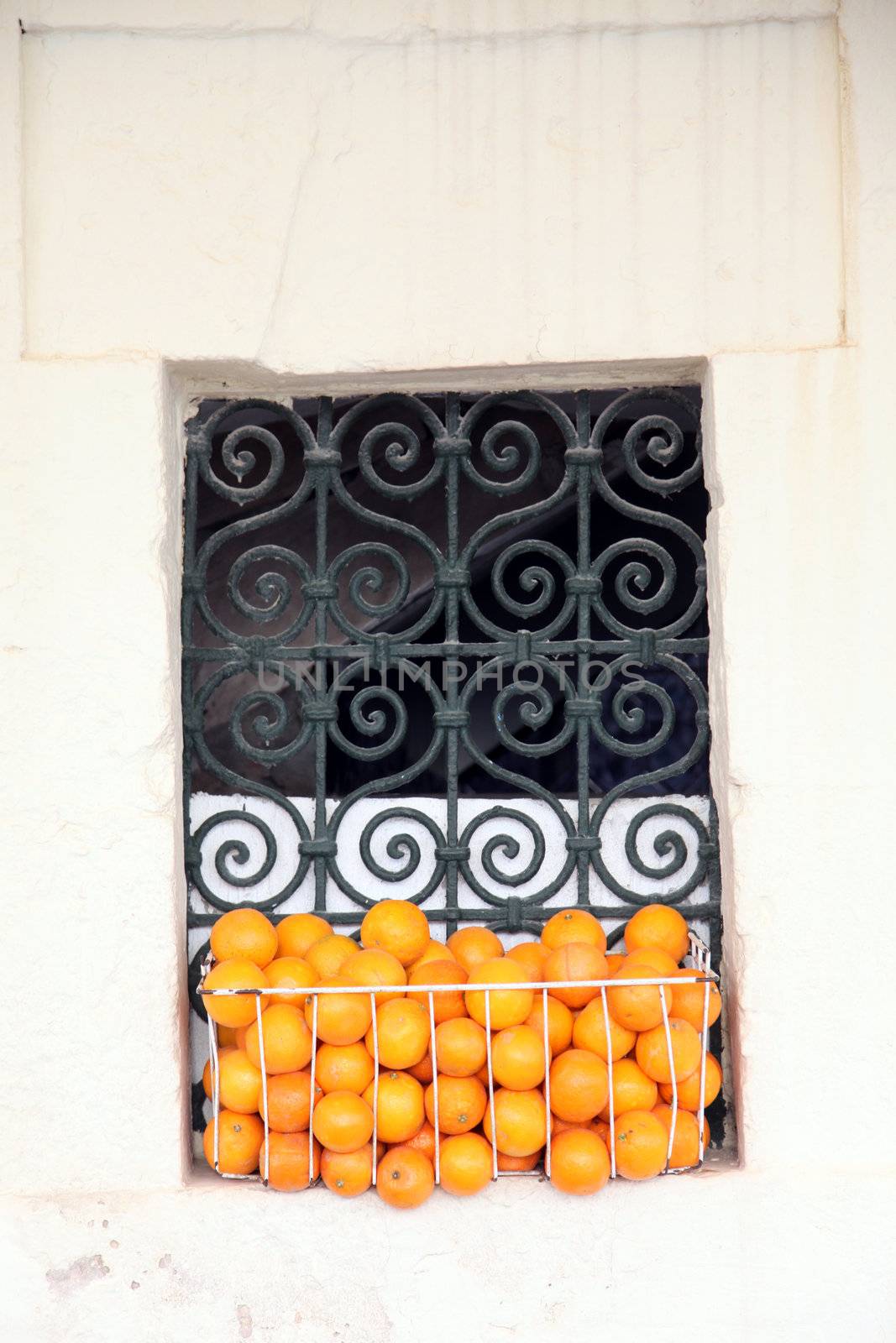 Old Tunisian window with oranges