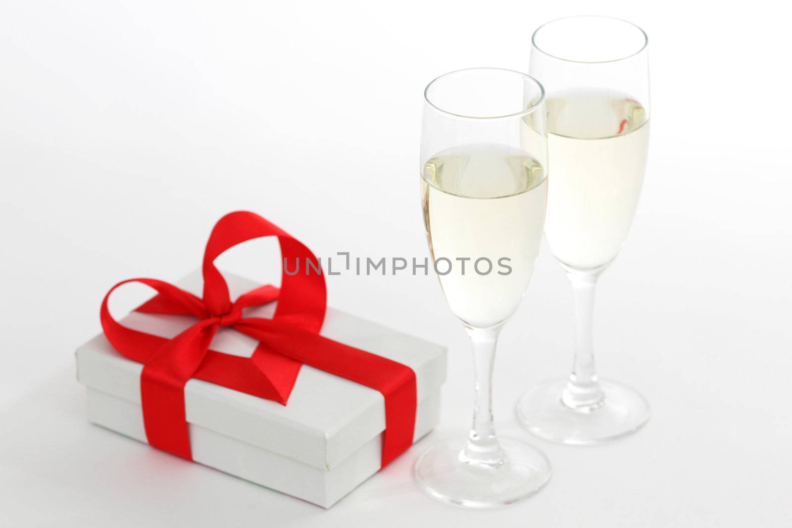 white gift with red ribbon