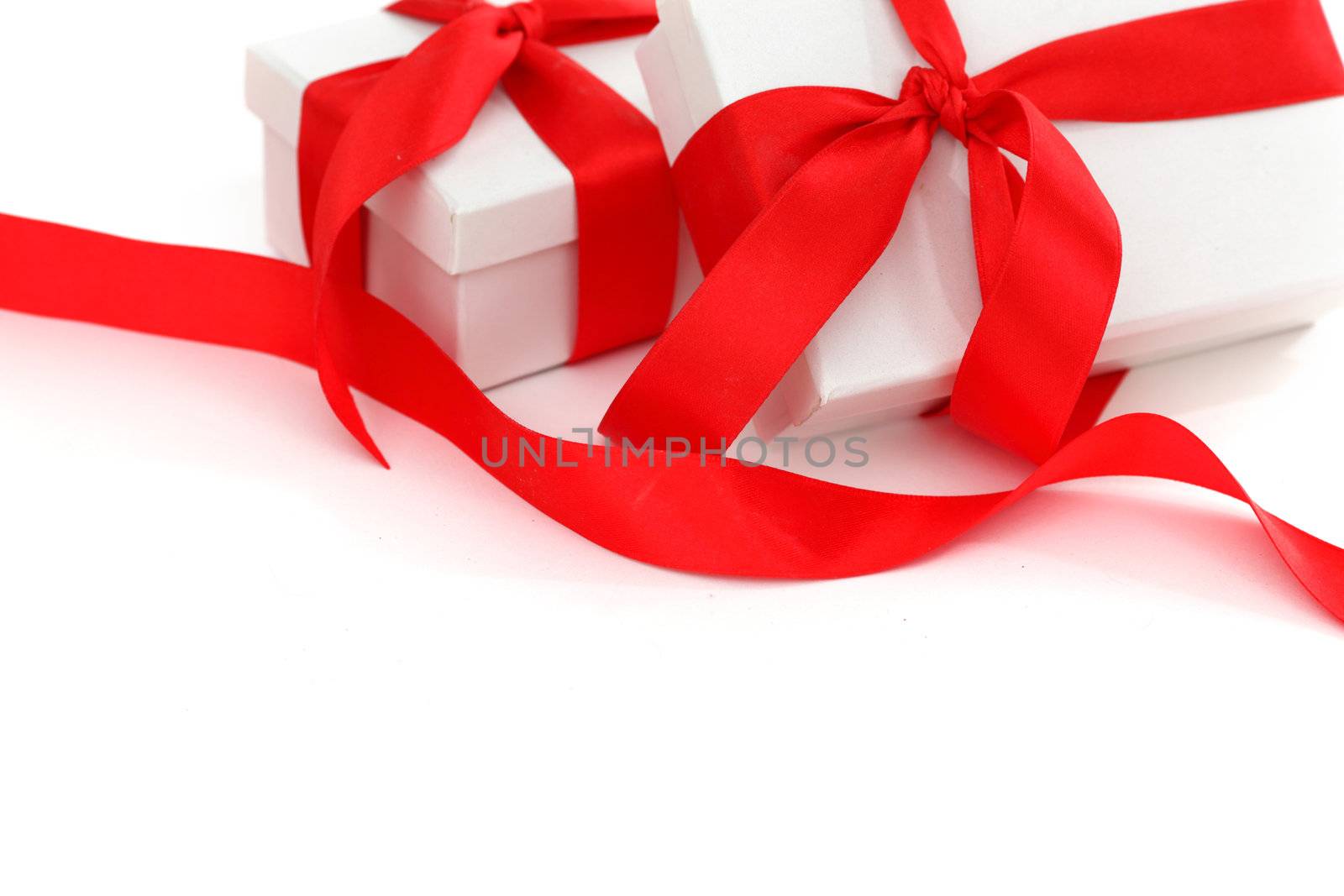 white gift with red ribbon