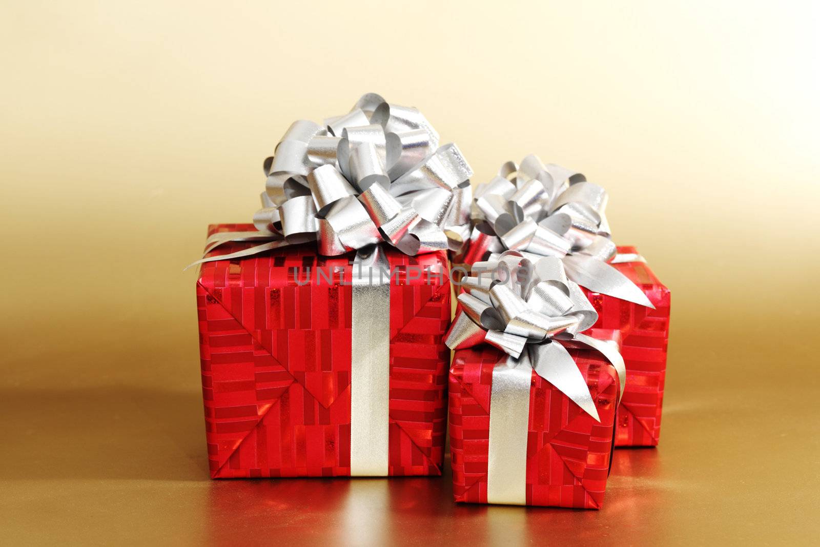 golden christmas gifts on gold background 