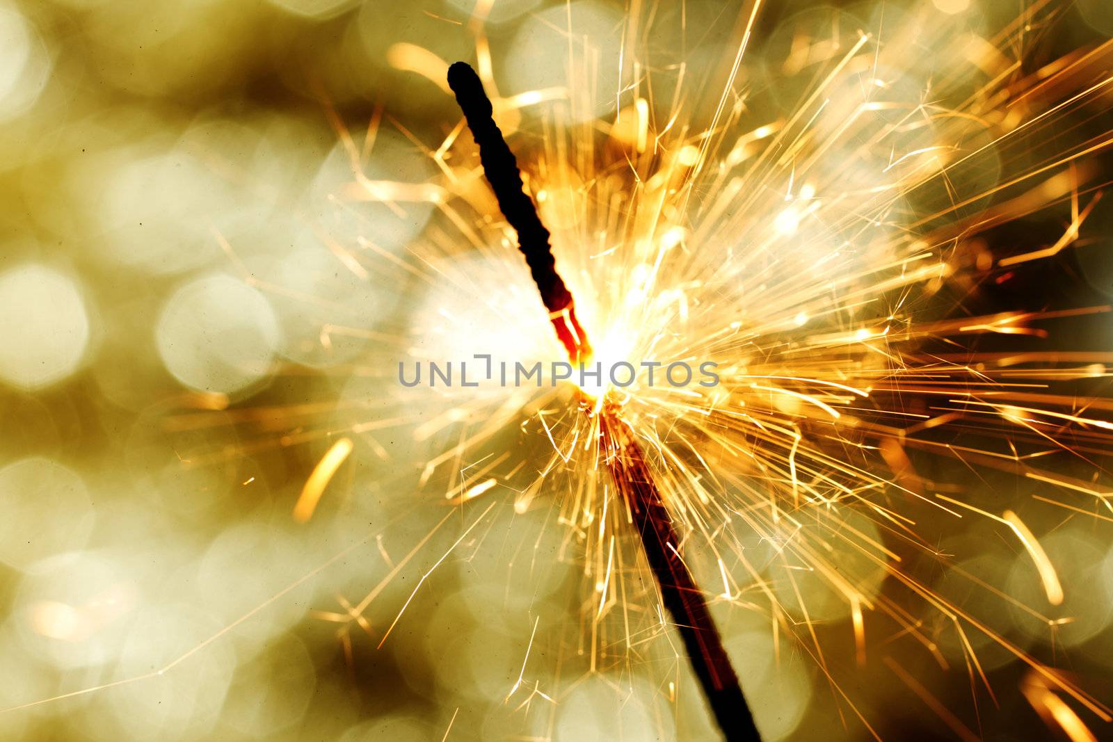 sparkler on gold  bokeh background macro close up