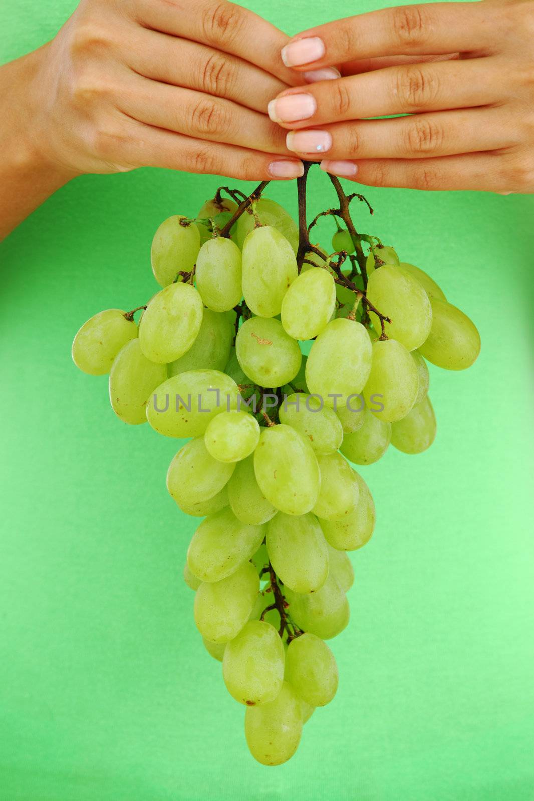 grape in woman hands by Yellowj