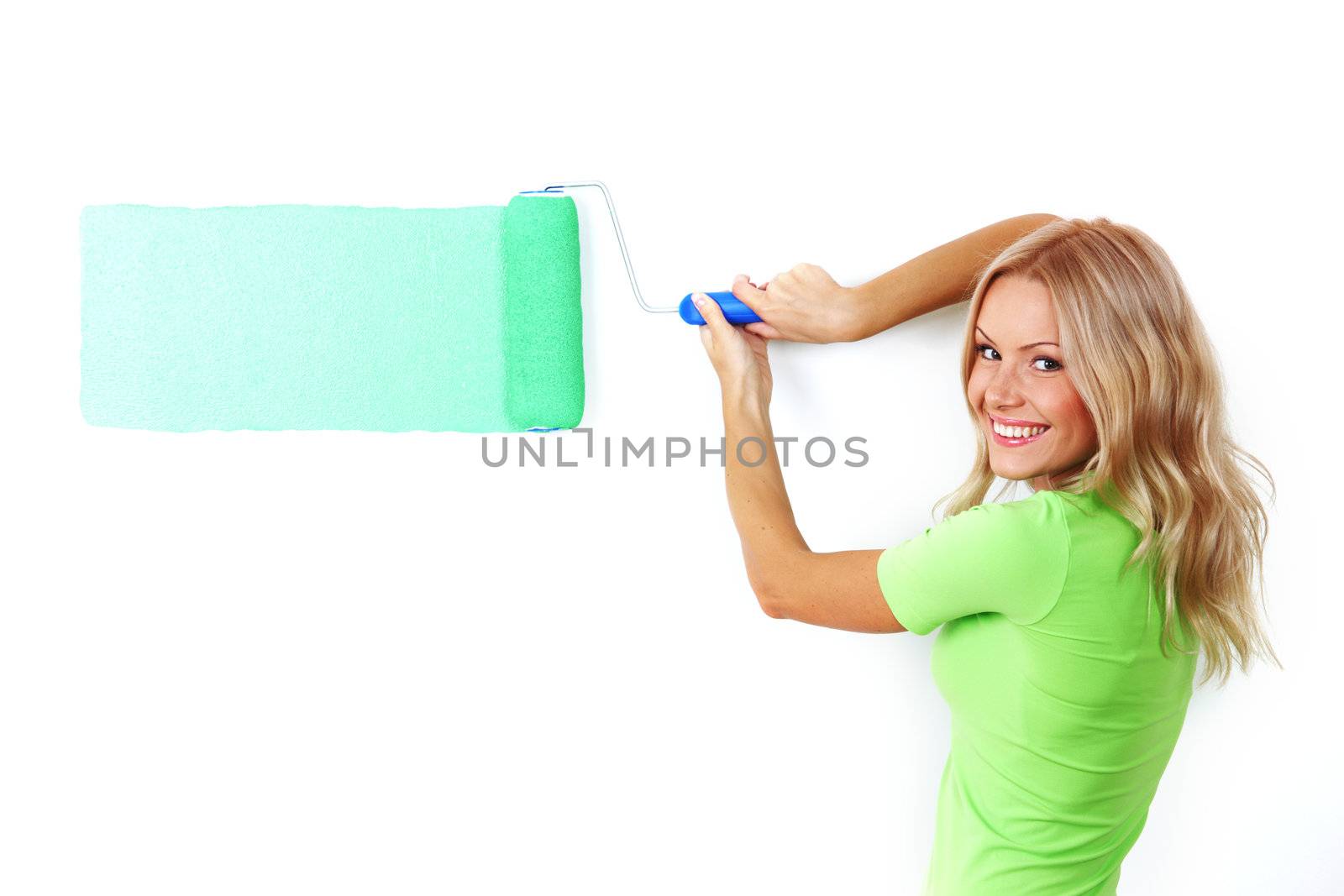 woman paints the wall brush