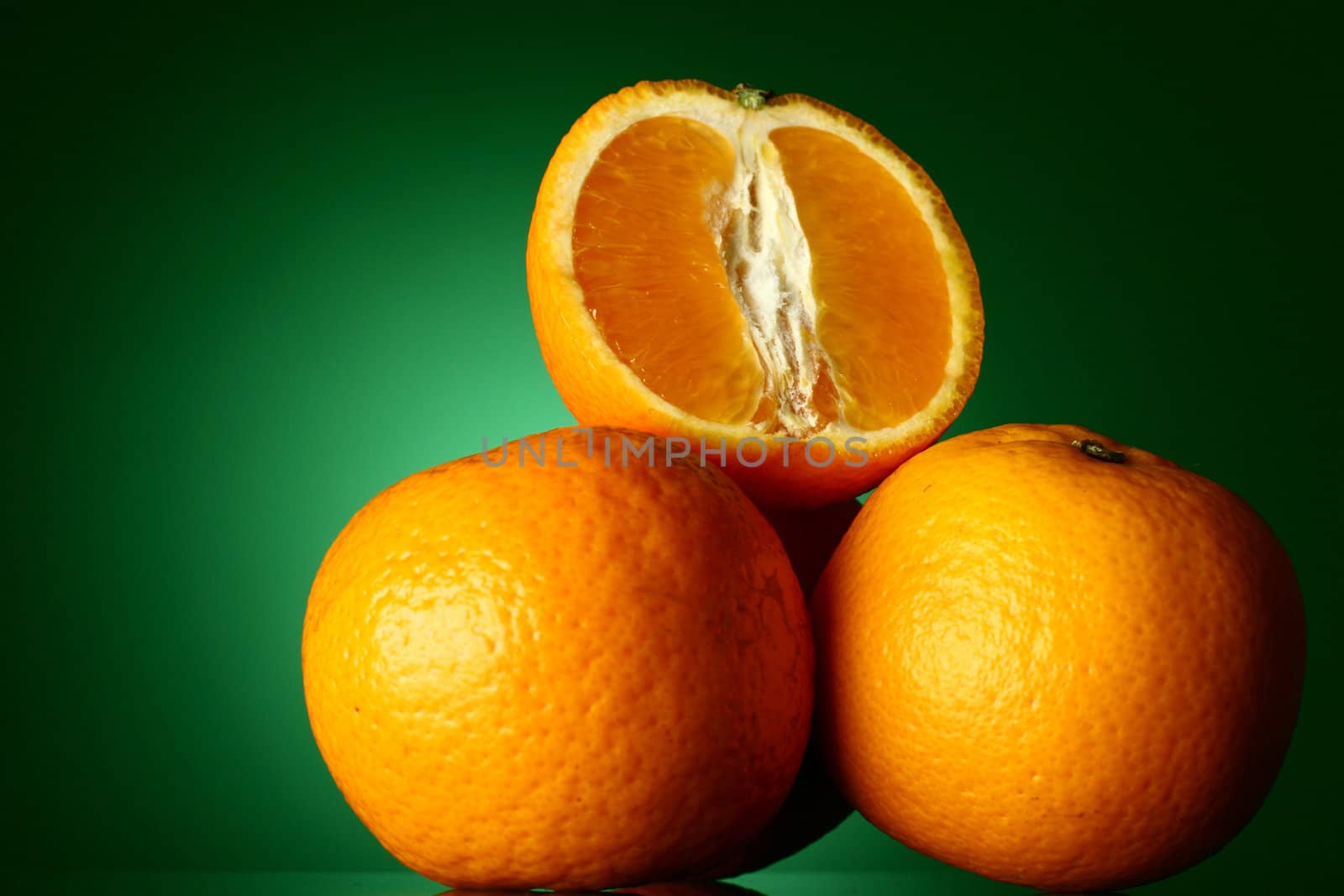 oranges isolated on green background