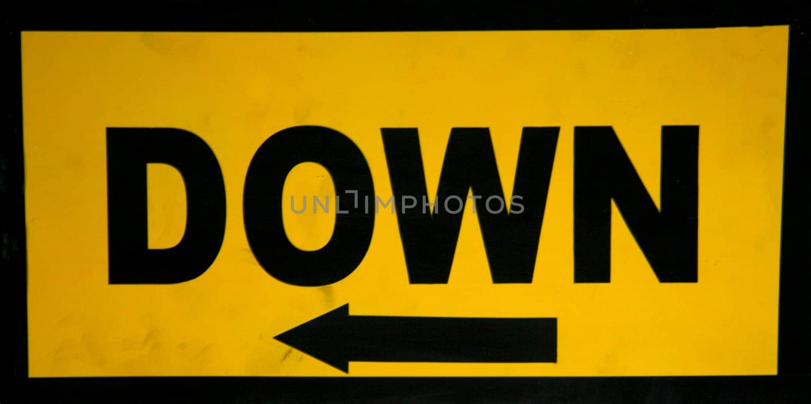 Signboard giving a direction on yellow background