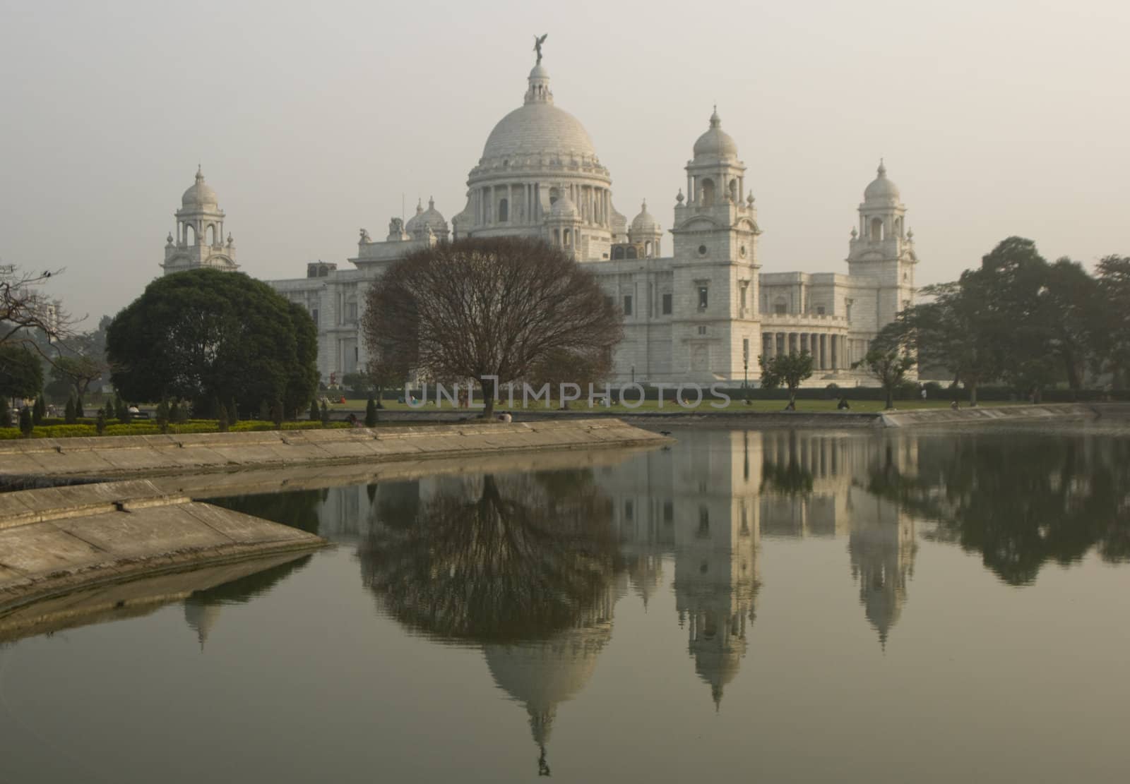 Victoria Memorial reflected in an ornamental lake at dusk. Kolkata, India