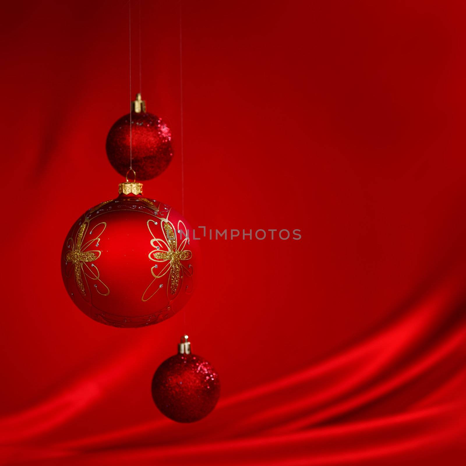  christmas balls on red satin background