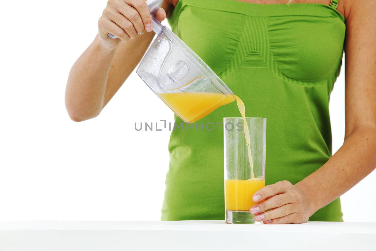 woman squeezes juice by juicer