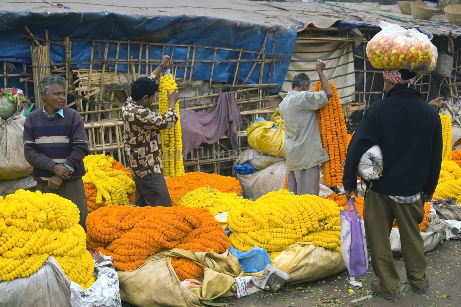 People buying and selling flowers at the flower market in Kolkata, West Bengal, India