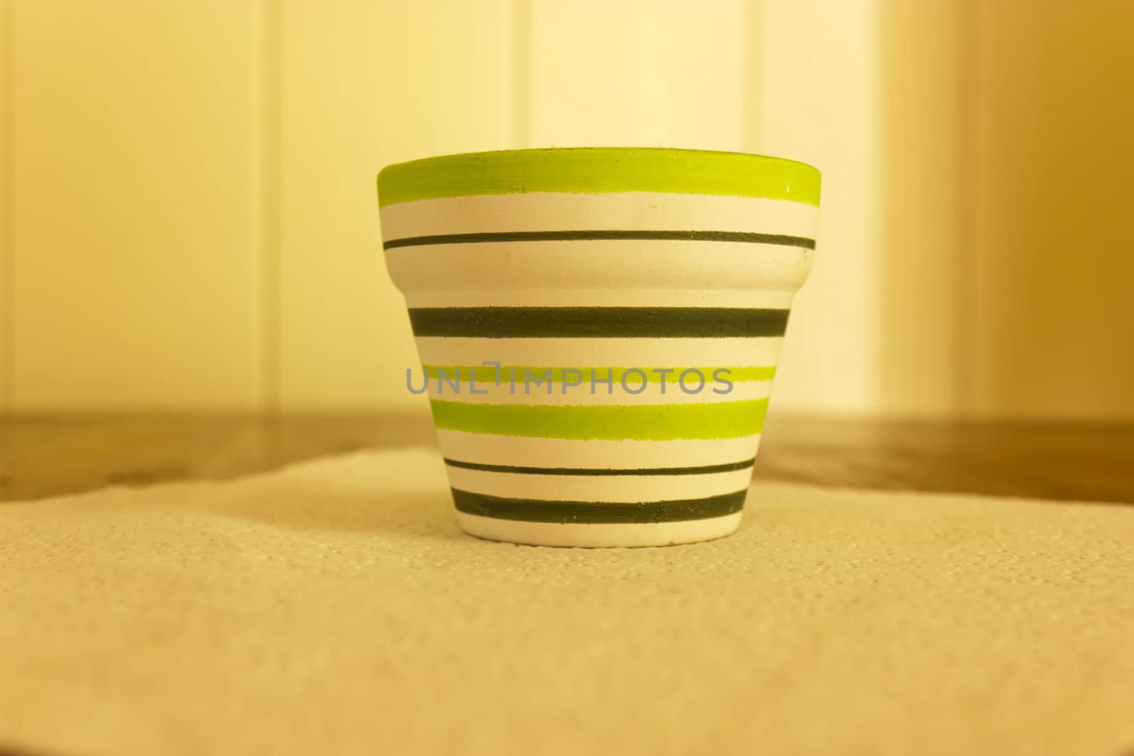 Small clay flower pots with color stripes.