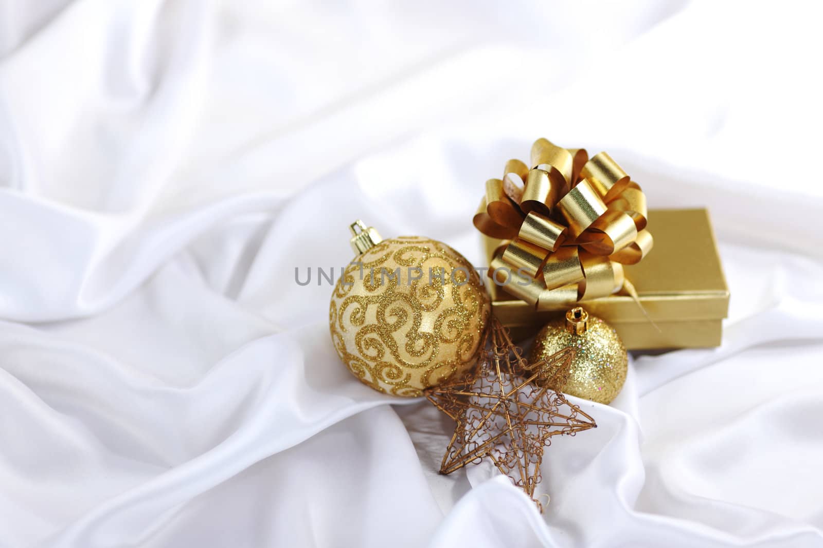  gold christmas ball on white silk