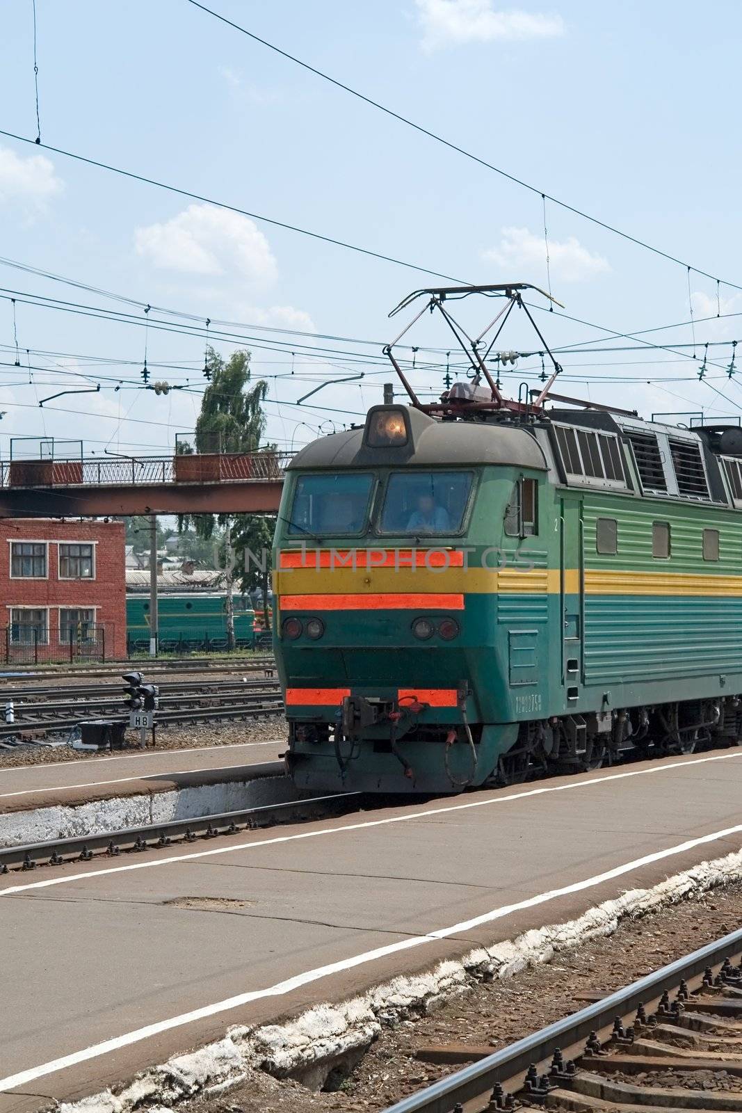 The railway. The train arrives to platform.