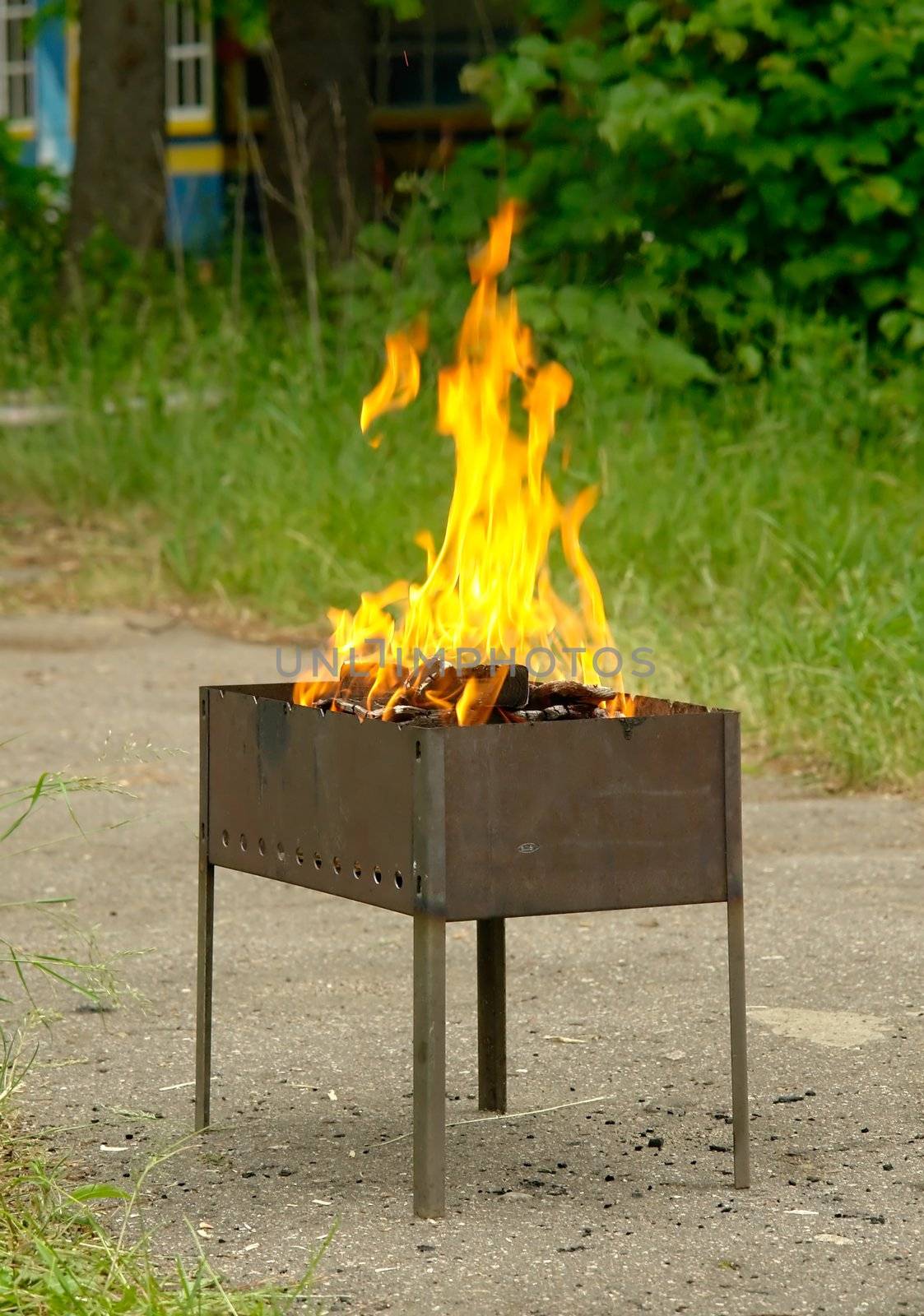 small road mangal with the burning firewood