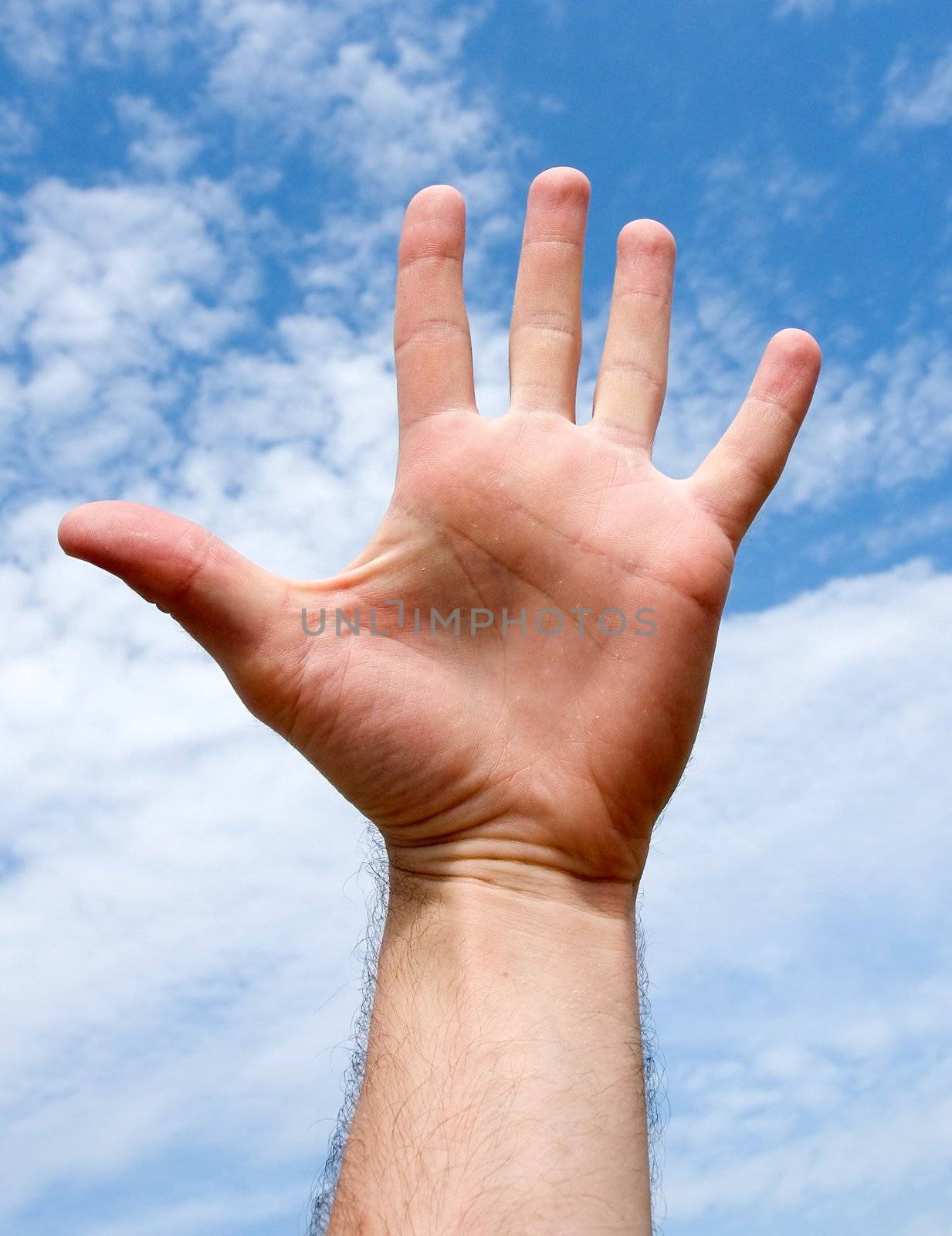 five. hand gesture with blue sky at background