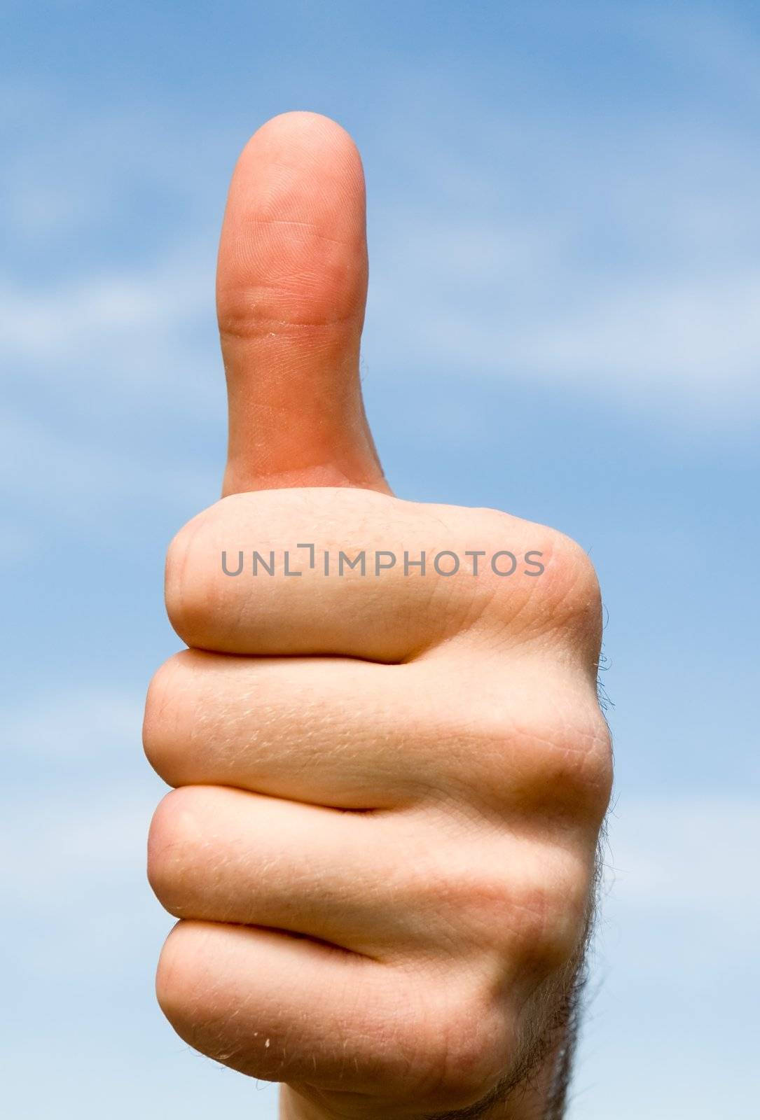 Thumbs up on a blue sky background