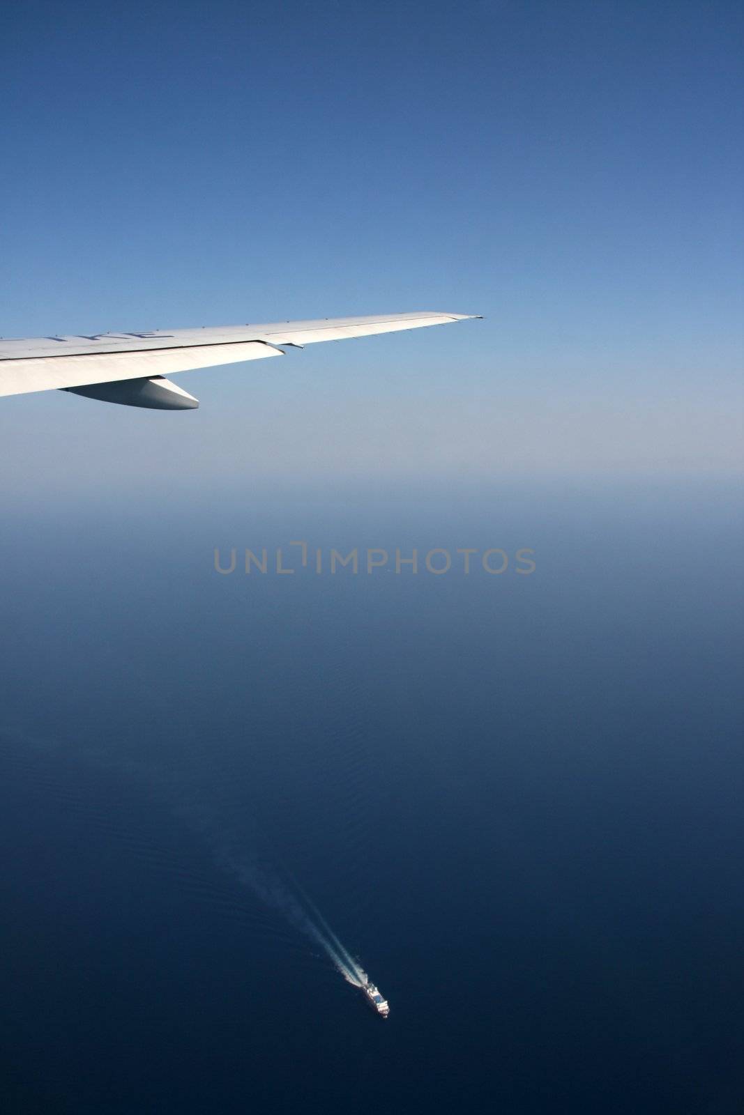 transportations airplane flying and ship shipping over aegian greece