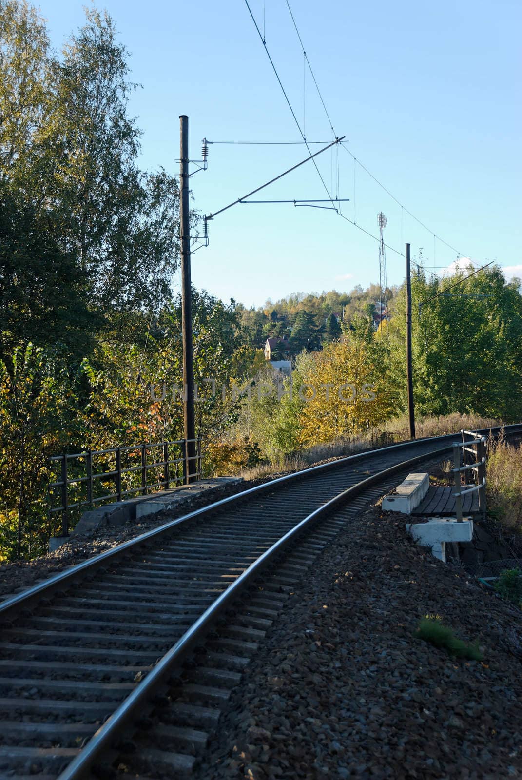 Single line railway track in autumn.
