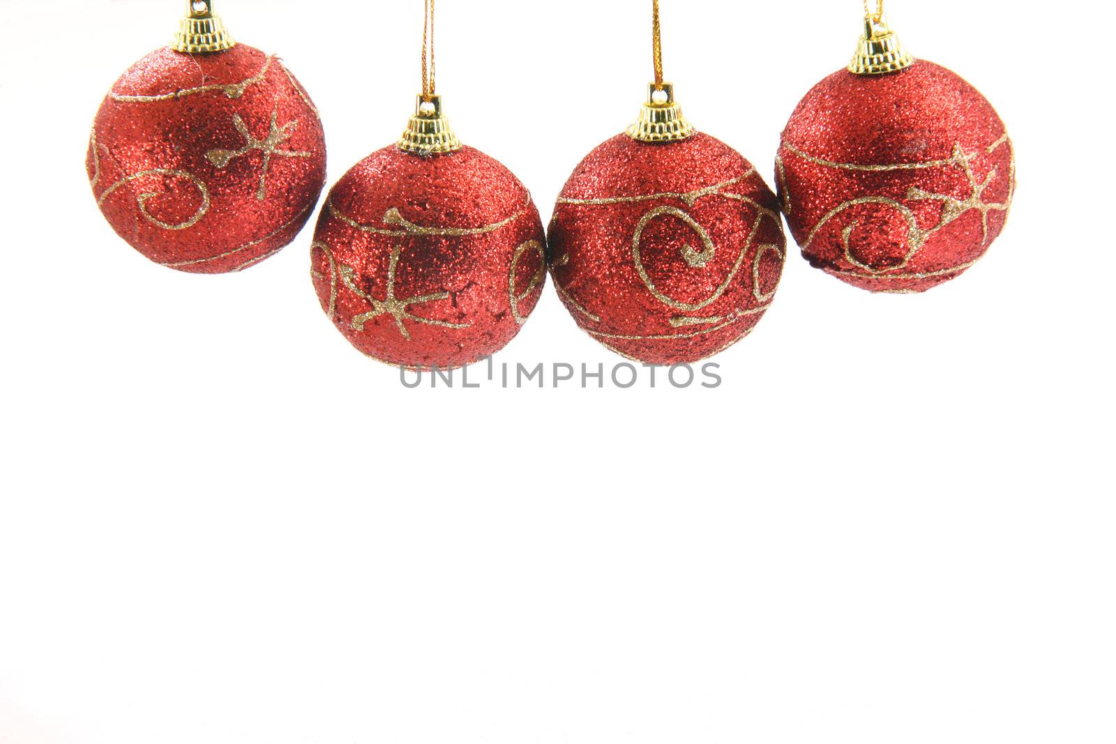 four red christmas decoration balls hanging isolated on white background front view