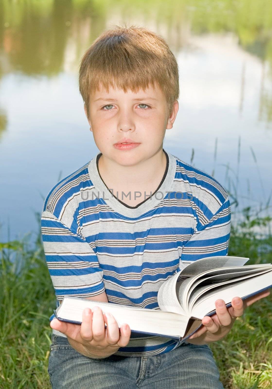boy reads a big book by stepanov