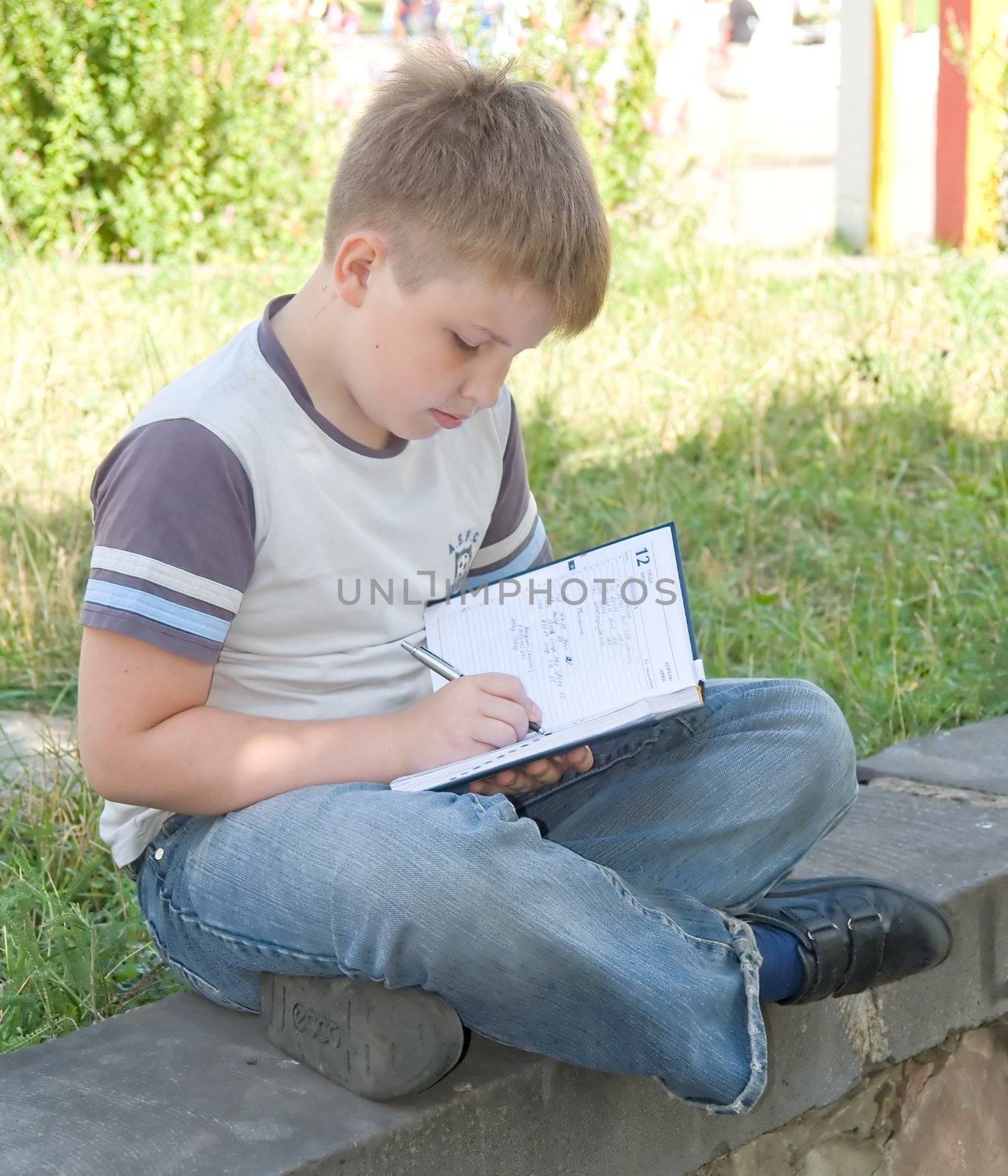 The little boy writes to writing-books