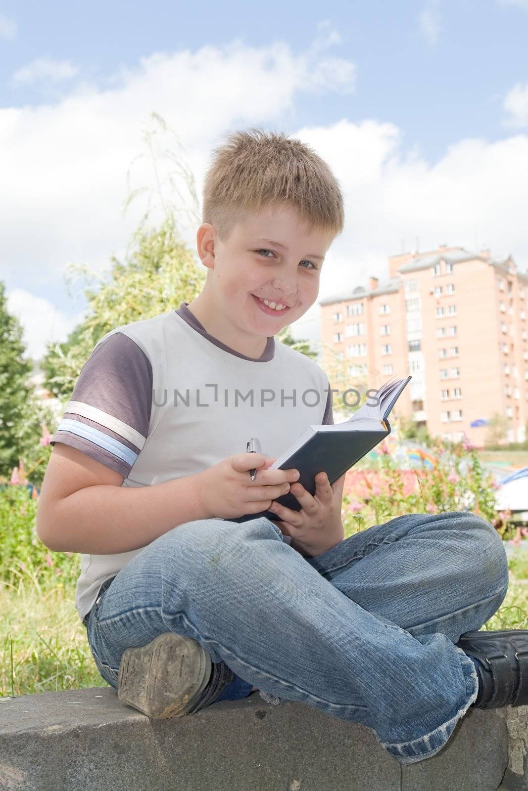 The little boy writes to writing-books