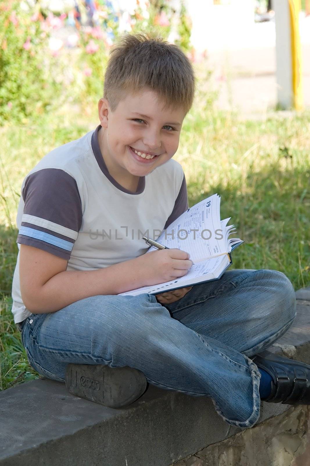 The little boy writes to writing-books