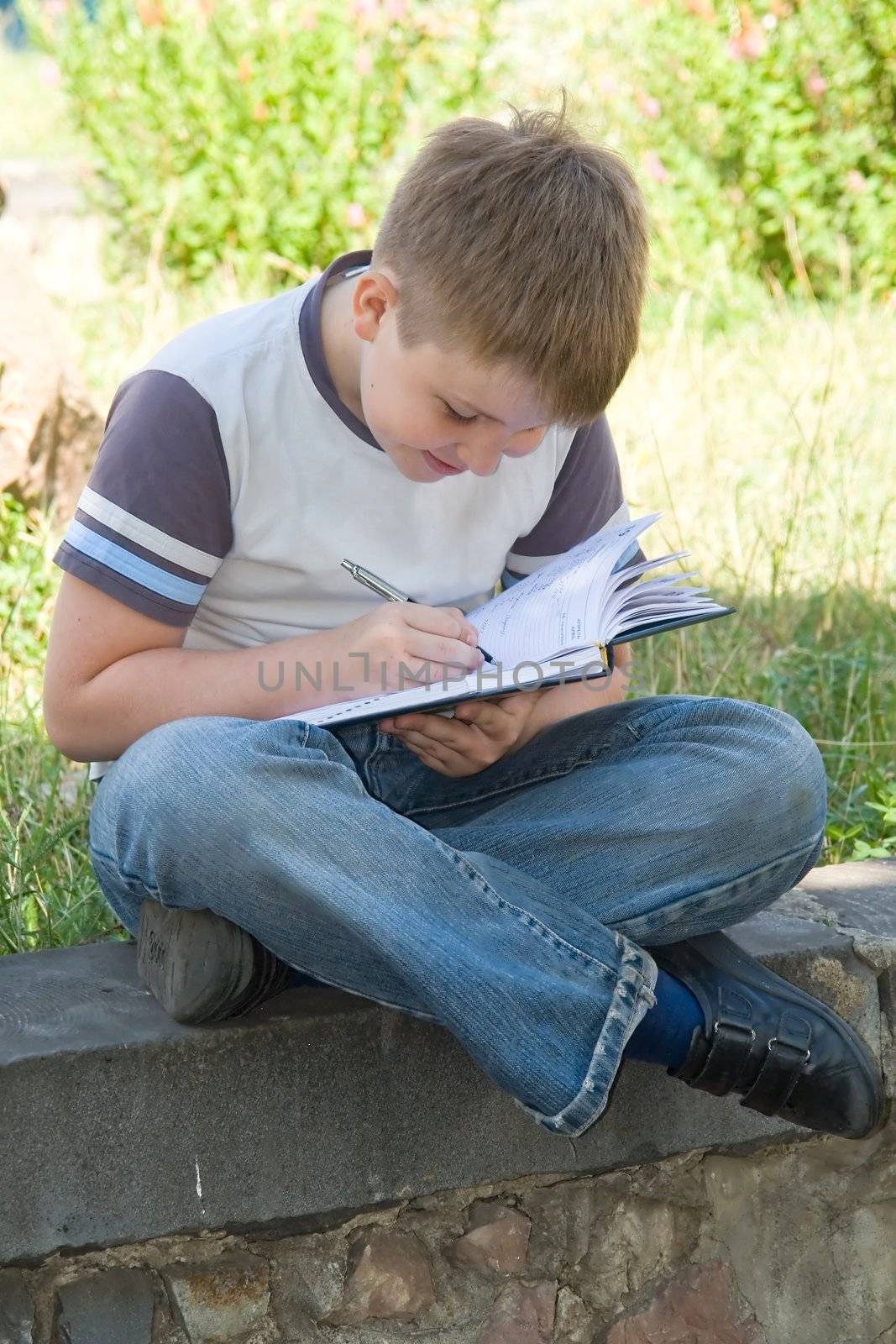 The little boy writes to writing-books