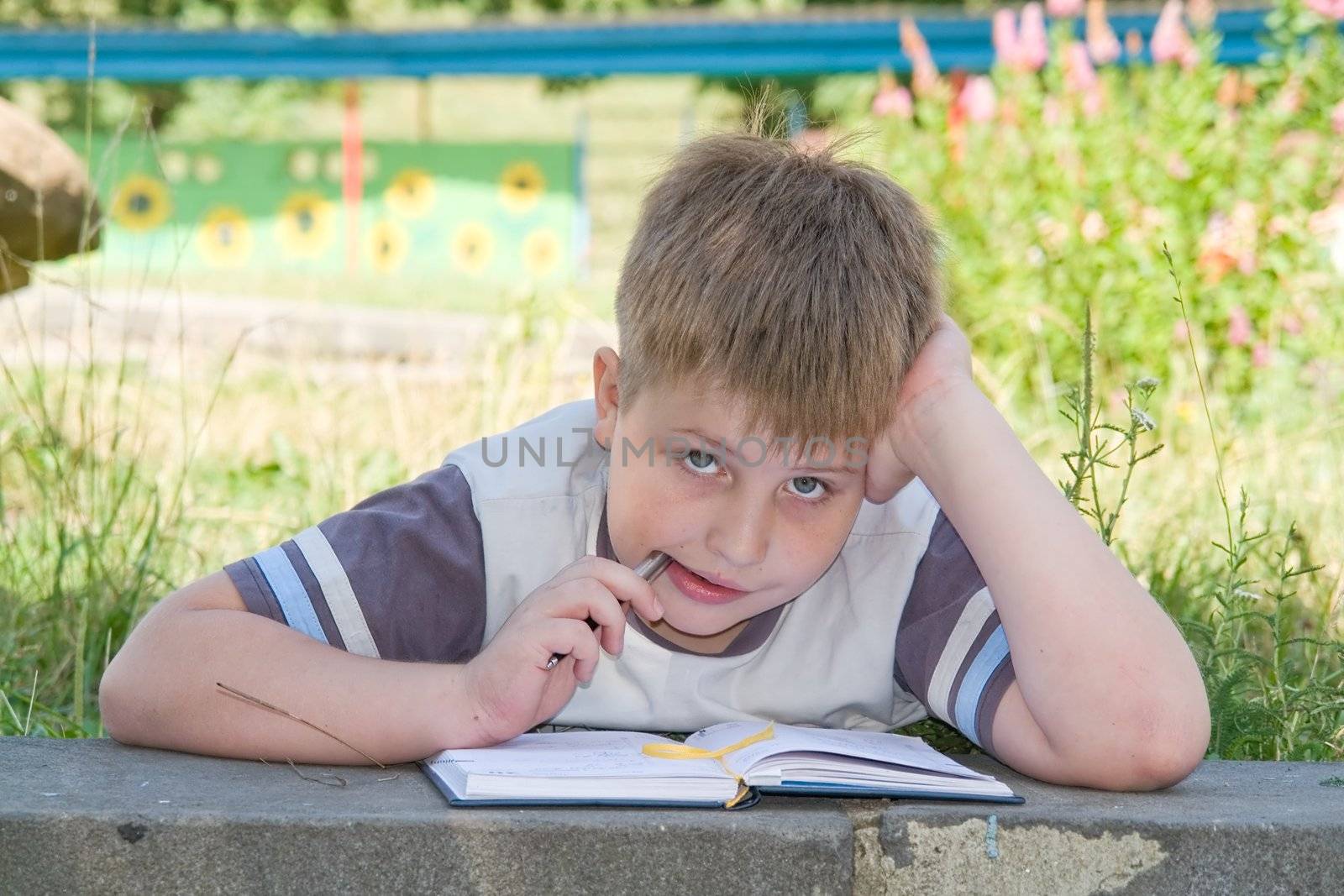 The little boy writes to writing-books