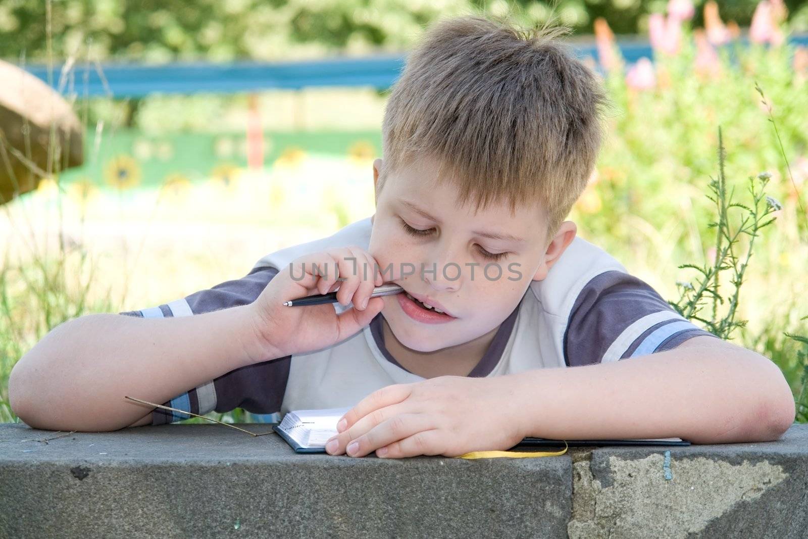 The little boy writes to writing-books